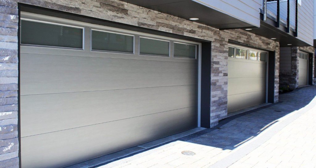 Double garage door installation at Sherman Oaks home with white raised panel design